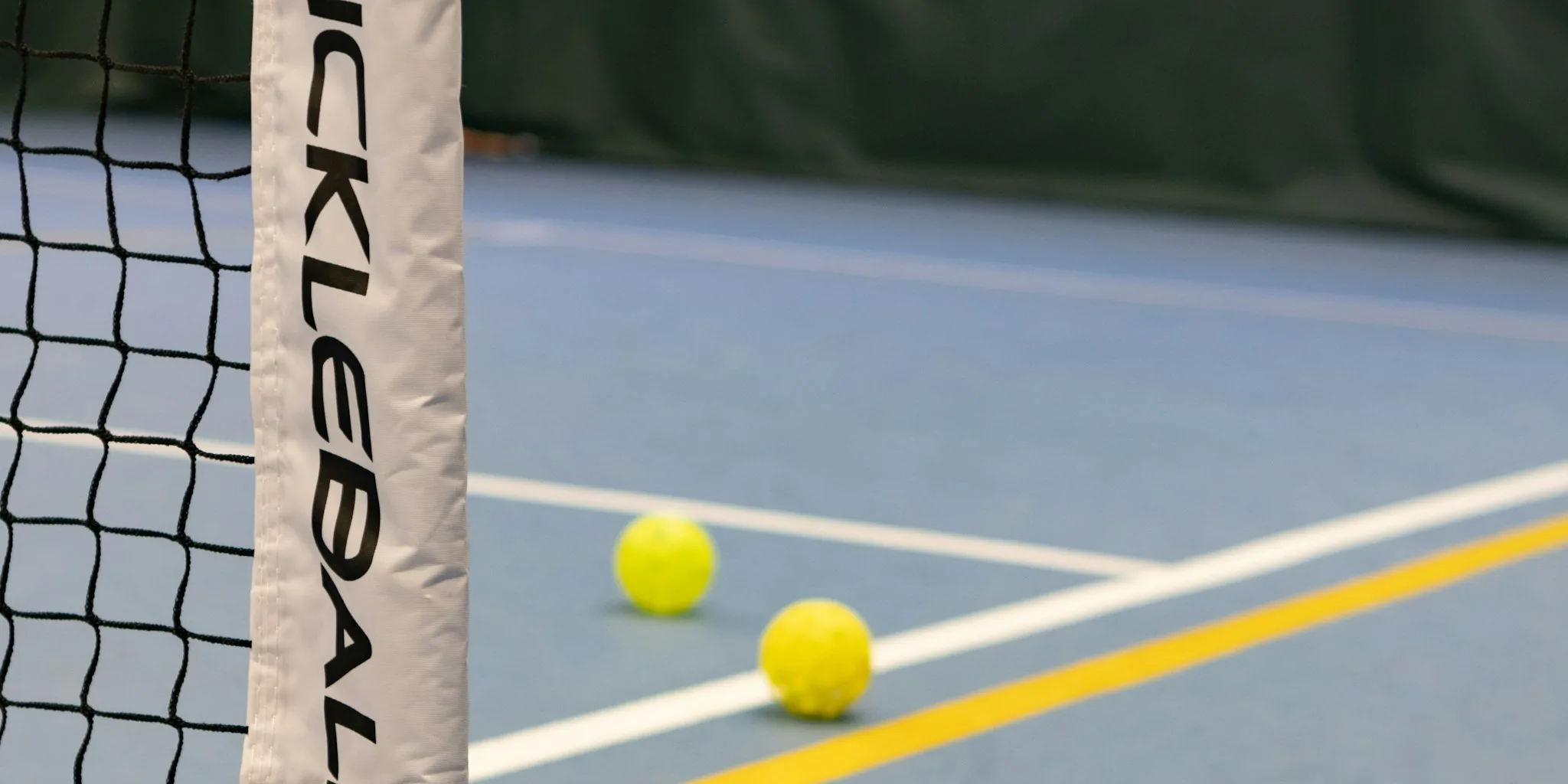 Man playing pickleball on outdoor court wearing athletic shoes and gear