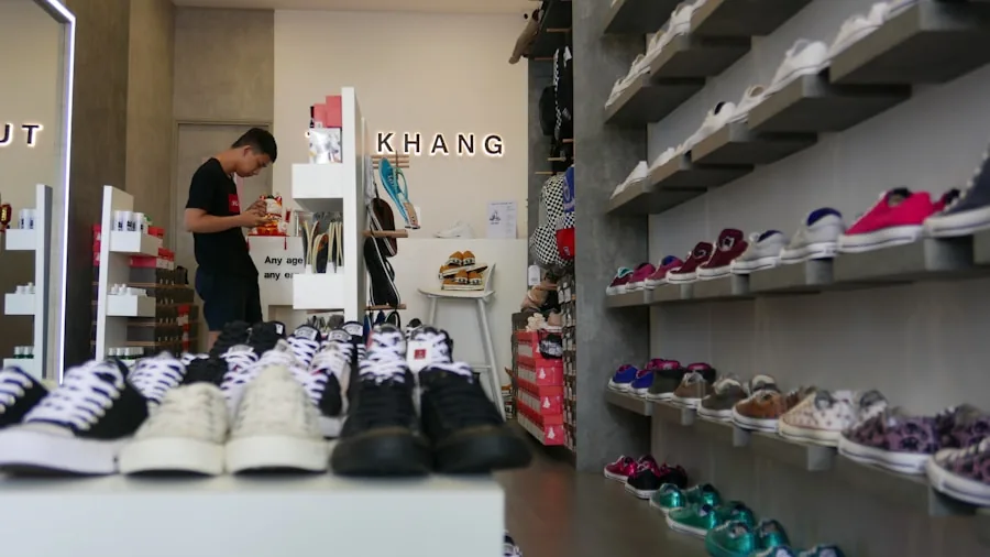 Man selecting affordable running shoes while shopping for athletic footwear in a store
