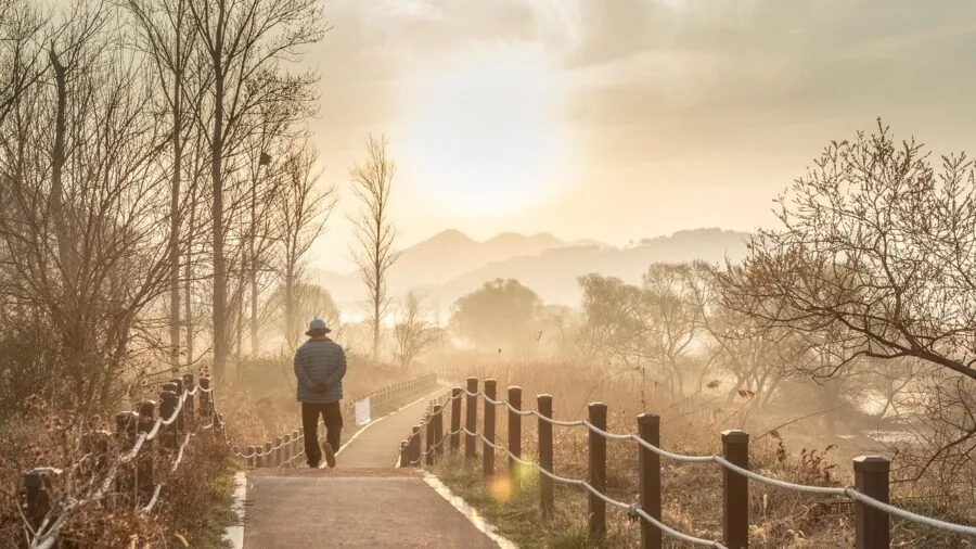 Man walking on outdoor path demonstrating natural gait and stride technique