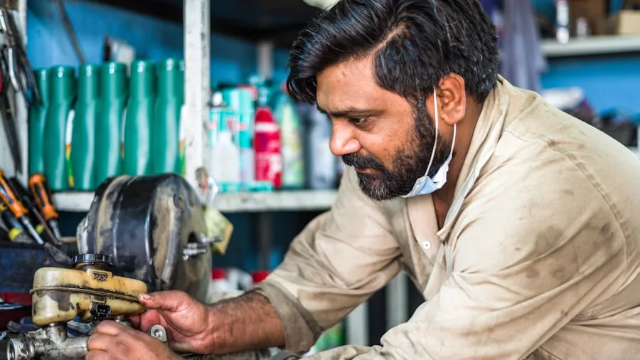 Mechanic applying torque force to loosen a corroded bolt on metal equipment