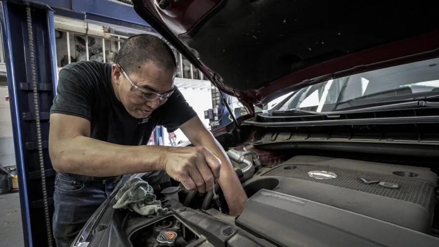 The %product_count% Best Car Batteries 6 Mechanic inspecting car battery terminals during vehicle maintenance service