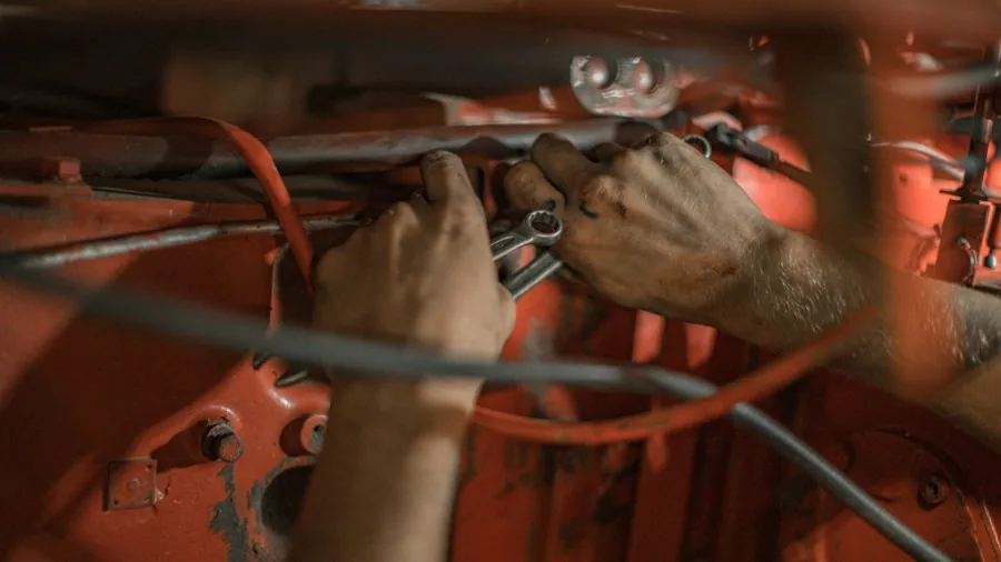 How Car Review Editors Shape Your Buying Decisions 2 mechanic working on car engine