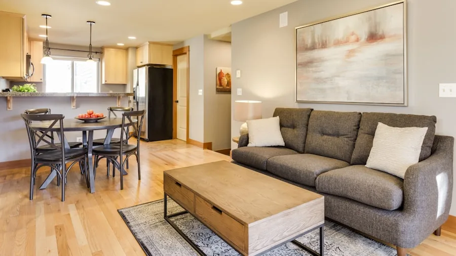 Modern kitchen with compact appliances near open living room, demonstrating kitchen-to-living space layout considerations