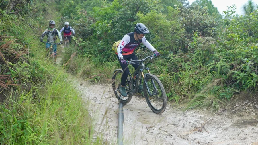 The %product_count% Best Mountain Bikes 4 Mountain biker navigating wet muddy terrain on forest trail during ride