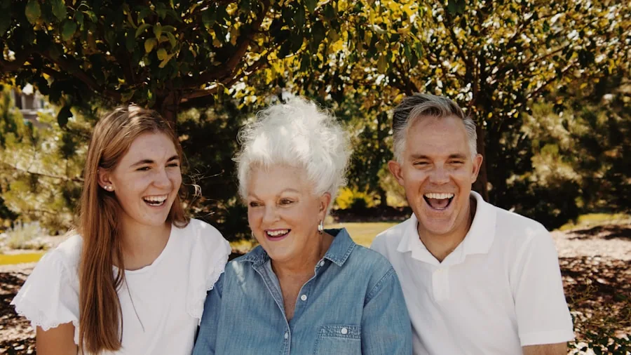 Multi-generational family members of different ages together in a warm home setting, representing health monitoring for infants, children, and adults
