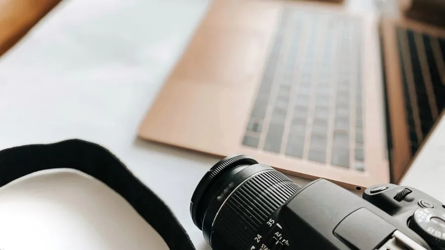 Music producer working on laptop during extended production session, focused on thermal performance and battery endurance