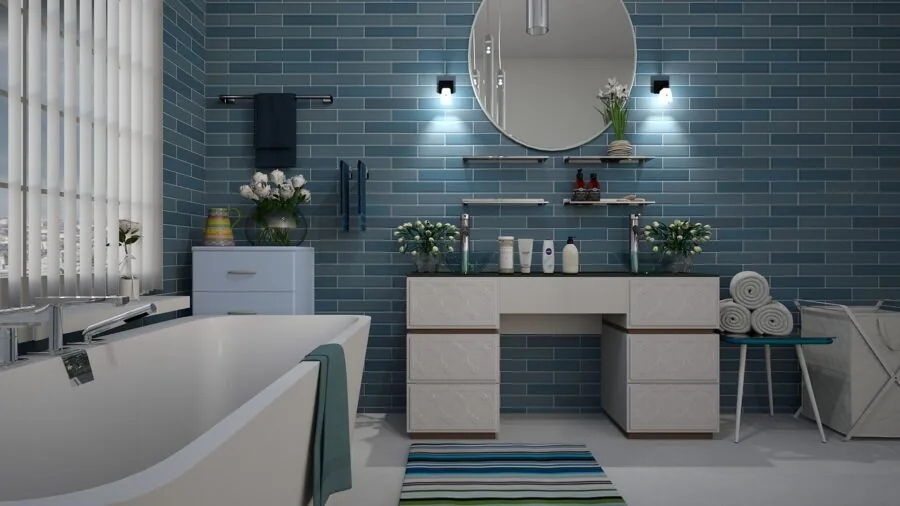 Neatly folded white and gray bath towels displayed in a modern bathroom setting