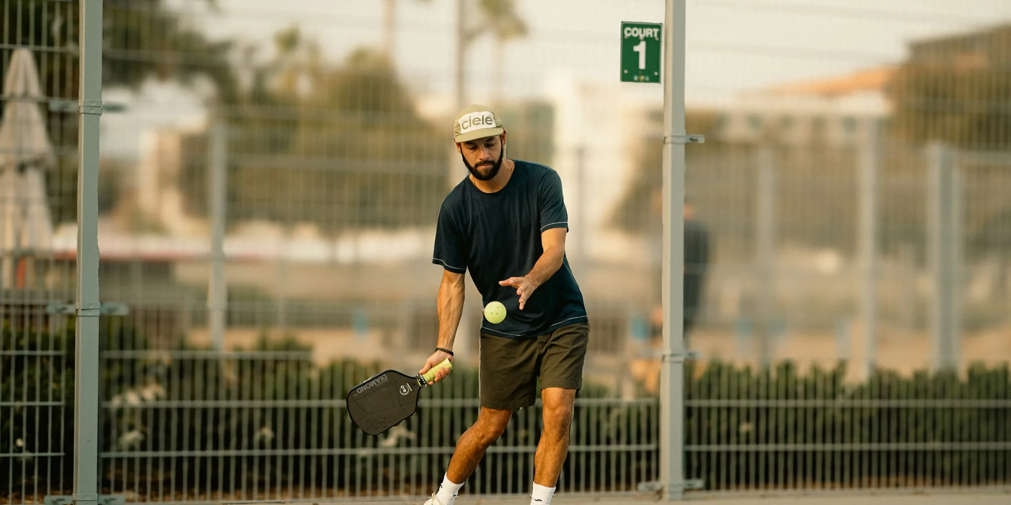 Older adults enjoying a game of pickleball on an outdoor court in natural daylight