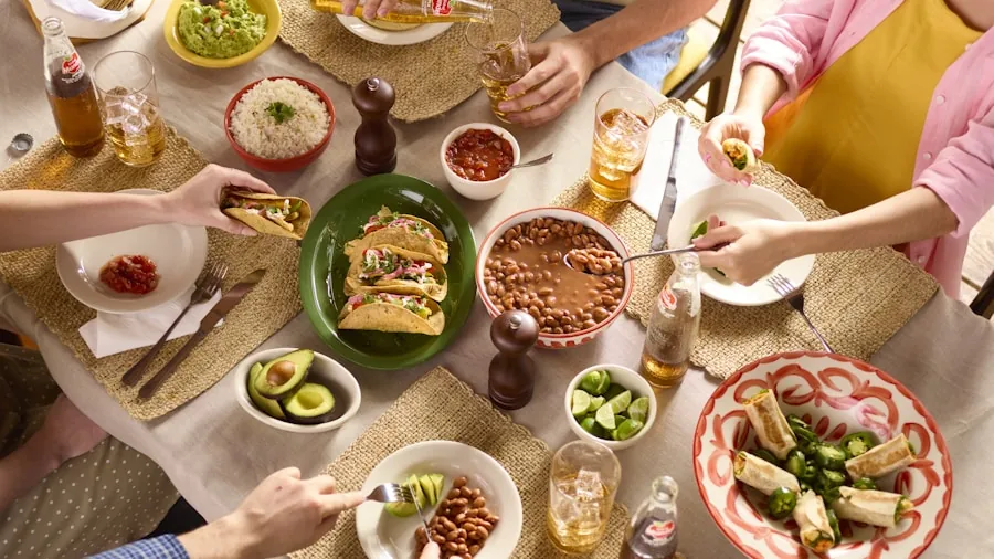 Overhead view of a casual family dinner table with place settings and dishes ready for a meal