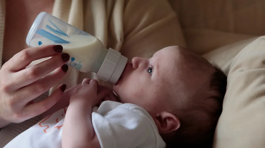 Parent bottle feeding infant with supportive pillow positioning