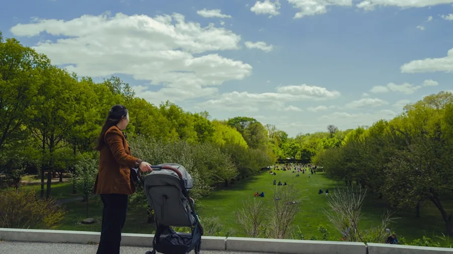 Parent changing diaper on baby outdoors in park setting with natural daylight