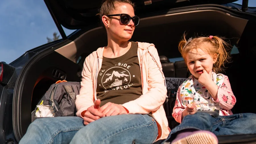 Parent charging mobile device with portable power bank while traveling, representing convenience and mobility on the go