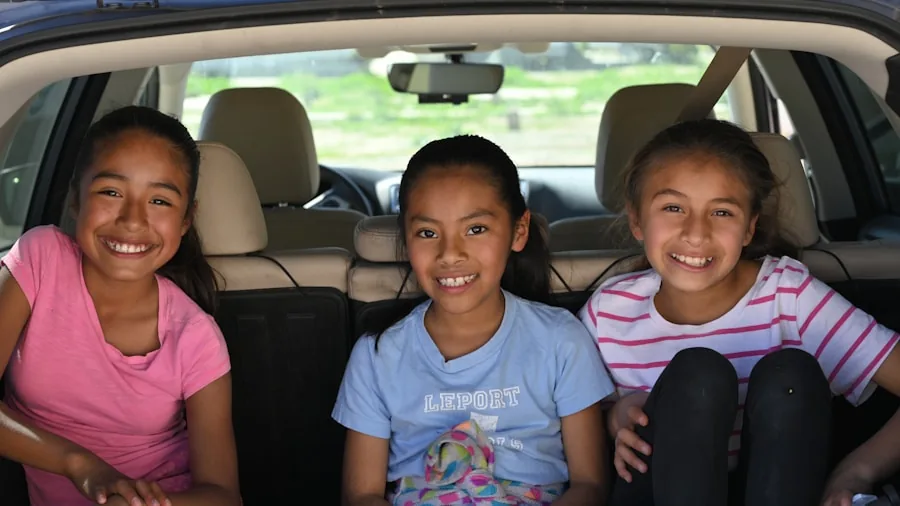 Parent installing convertible car seat in vehicle for child safety