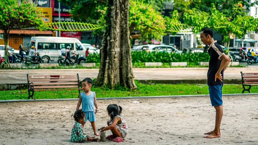 Parent pushing double stroller with two children on sunny park path, family lifestyle moment