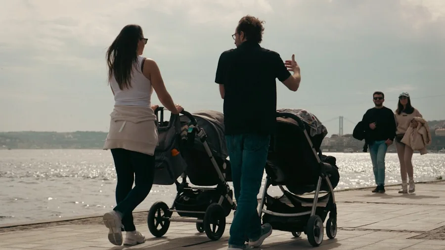 Parent pushing stroller on sidewalk during daytime walk with child