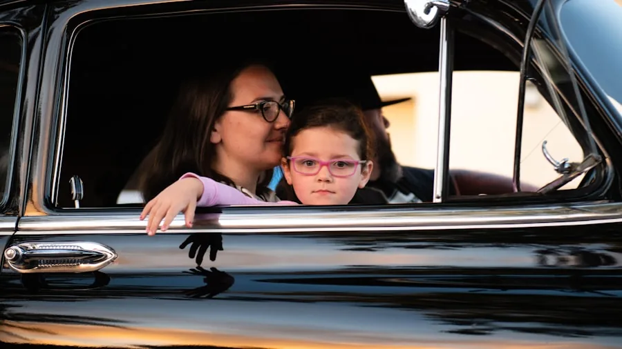 Parent securing child in car seat during family road trip, emphasizing vehicle safety and family care