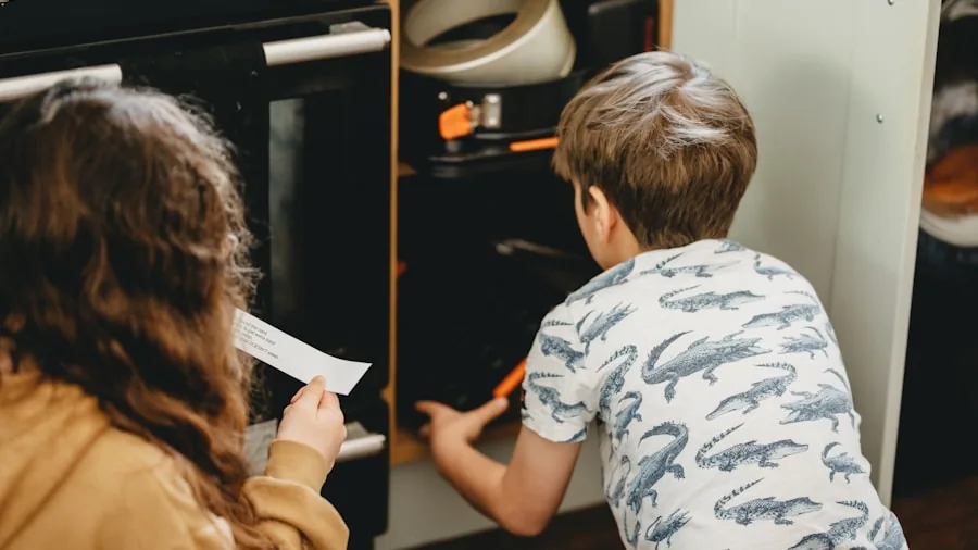 Parent supervising child in kitchen near cooking appliances with safety features