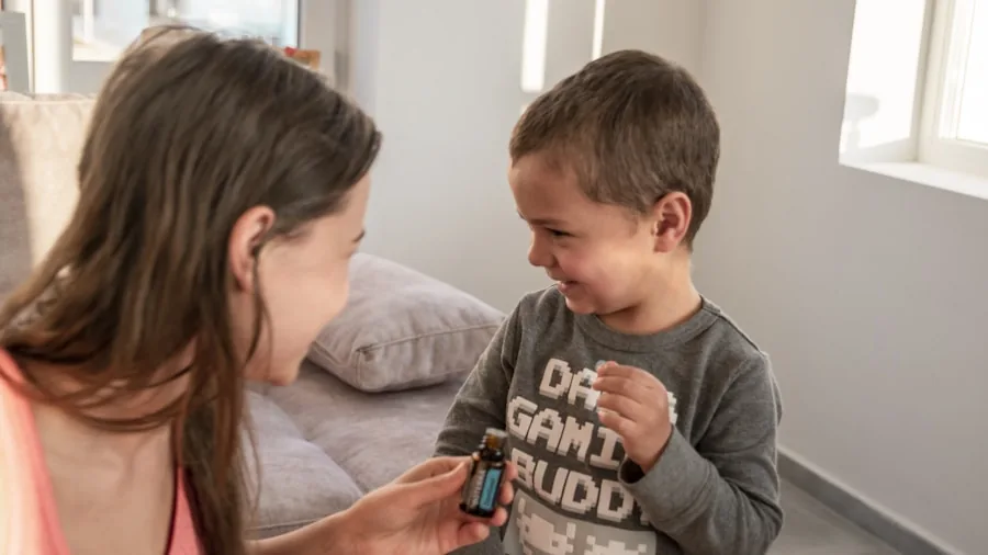 Parent using infrared forehead thermometer to check sick child's temperature at home
