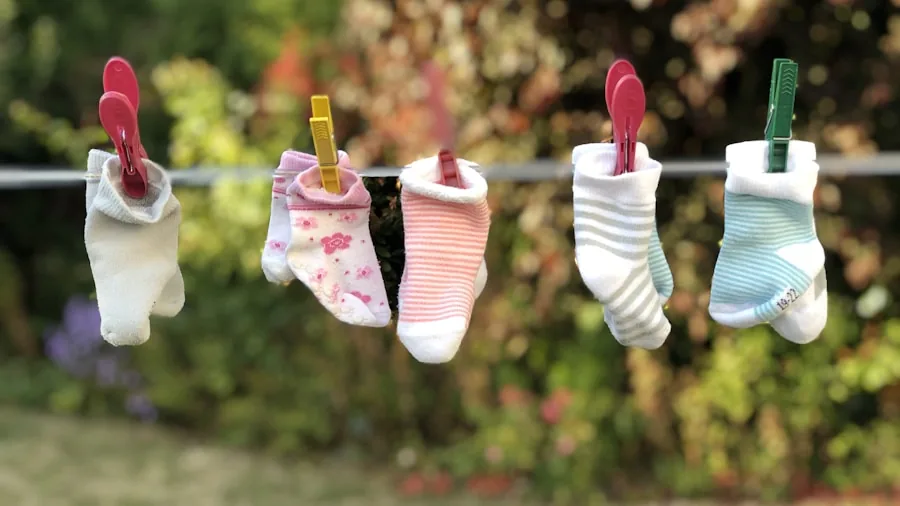 Parent washing baby clothes in washing machine, caring for infant items in home laundry room