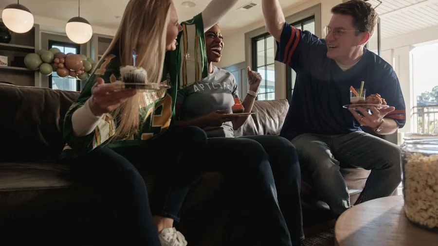 7 Tips for Watching the World Cup 2026 Final on Your TV at Home 2 people cheering at home watching soccer