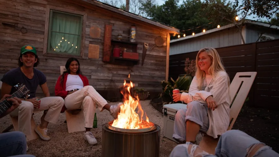 The %product_count% Best Smokeless Fire Pits 3 People enjoying a smokeless fire pit outdoors during evening with reduced smoke and clear air