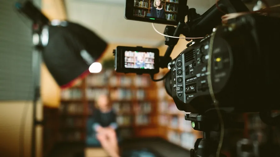 Person adjusting camera angle while recording video content outdoors in natural lighting