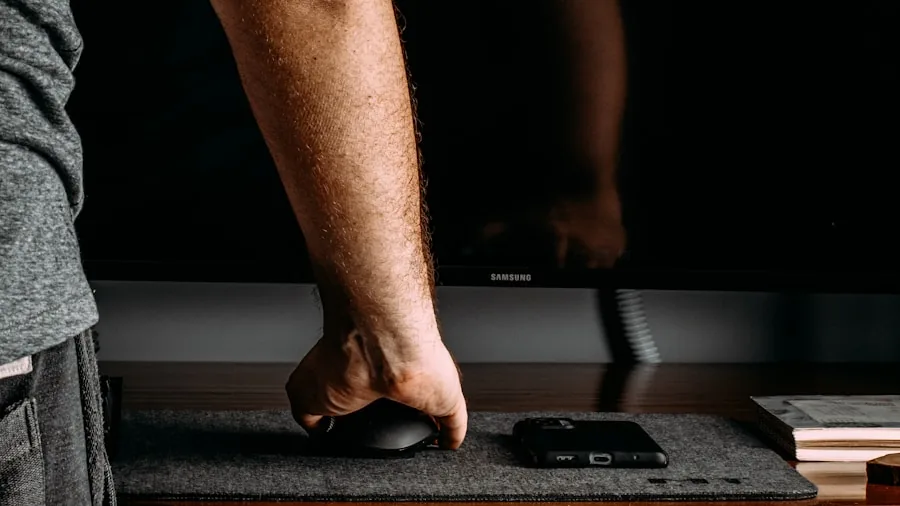 The %product_count% Best OLED Monitors 4 Person adjusting computer monitor stand height for ergonomic workspace comfort