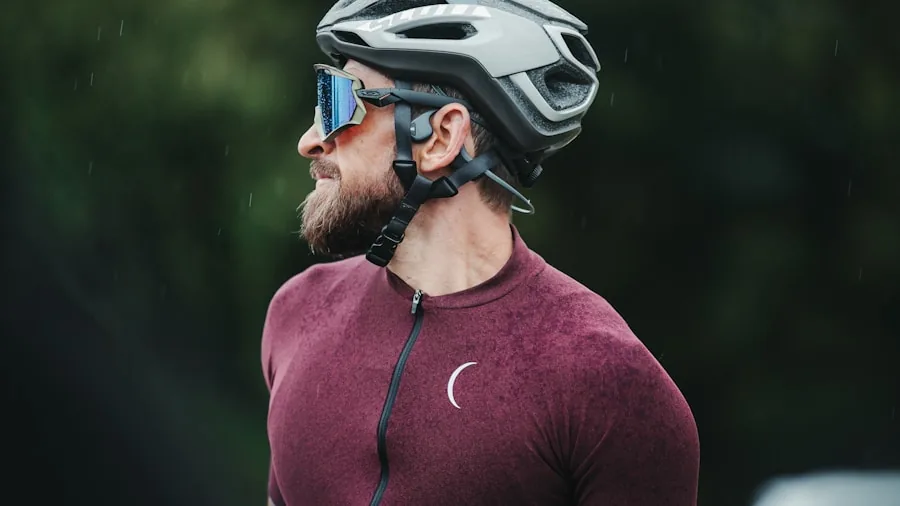 Person adjusting cycling helmet strap while preparing for ride outdoors