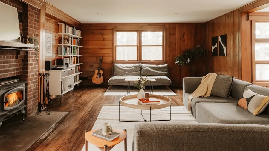 The 11 Best Smart Thermostats 3 Person adjusting home thermostat on wall in modern living room interior