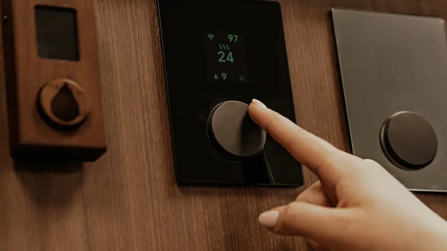 The 11 Best Smart Thermostats 4 Person adjusting home thermostat on wall to save energy and reduce heating costs