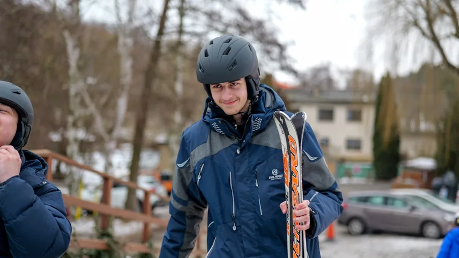 Person adjusting ski helmet fit while preparing for winter mountain sports activity