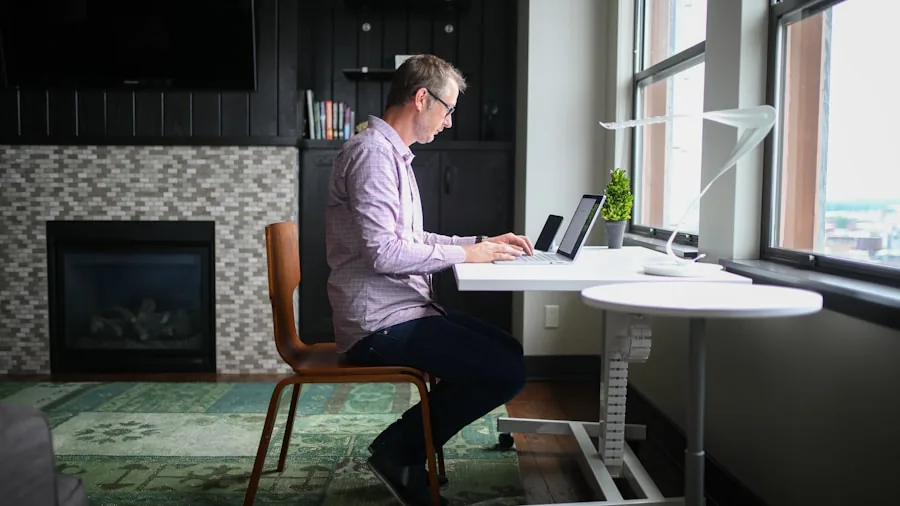Person adjusting standing desk height for proper ergonomic posture while working