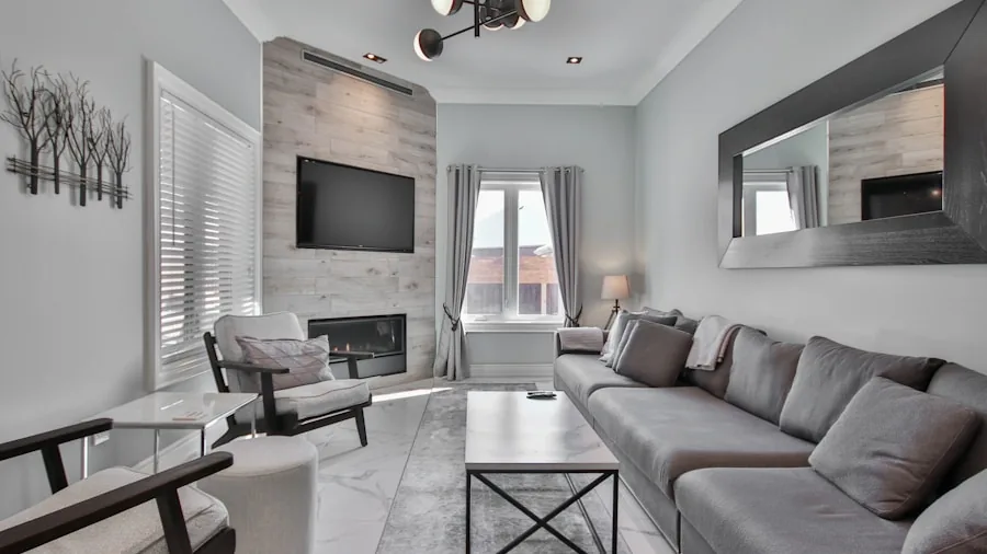 Person adjusting TV angle on wall mount in modern living room for optimal viewing position