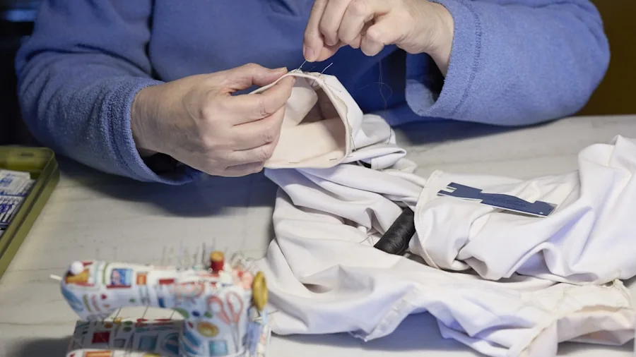 Person applying stain remover to clothing fabric during laundry day