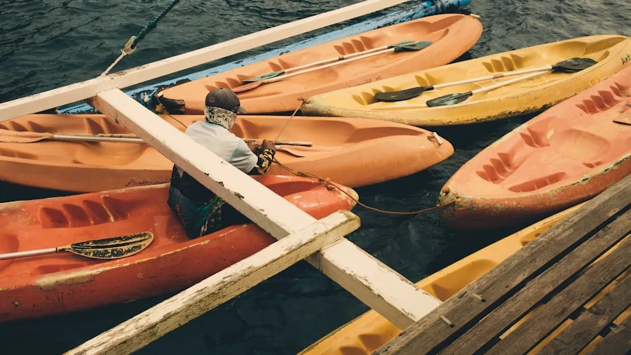 The %product_count% Best Kayaks for Fishing 3 Person arranging fishing tackle and equipment in kayak on calm water before departure