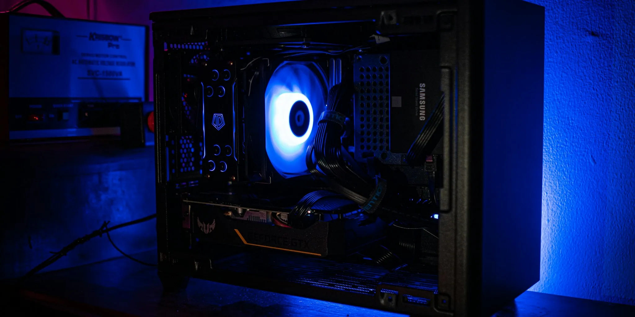 Person assembling computer components at desk for gaming setup
