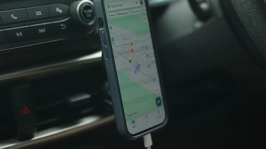 Person attaching smartphone to car dashboard mount while driving on road trip