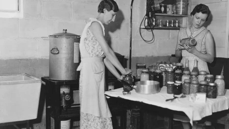 Person canning food in a bright kitchen with jars and fresh ingredients on countertop