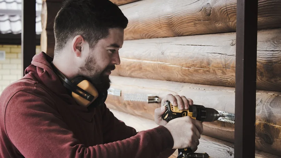 Person carefully adjusting rotary tool speed dial while working on woodworking project in workshop