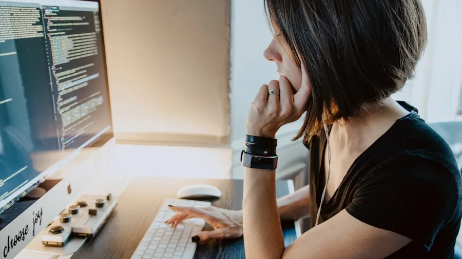 Person carefully examining and comparing computer components while making a purchase decision at home