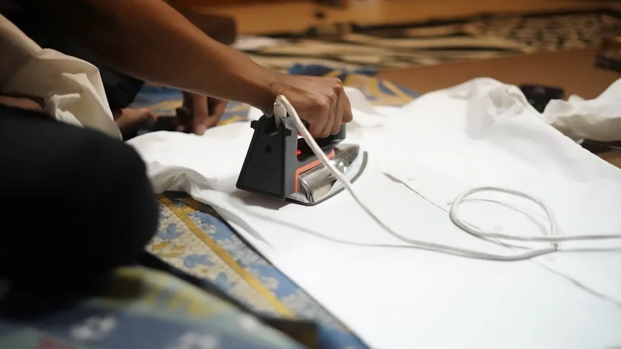 The 8 Best Ironing Boards 4 Person carefully ironing delicate fabric on ironing board with concentrated focus on clothing care