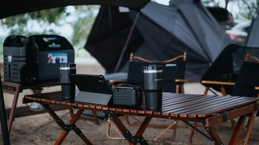 Person charging multiple devices and gadgets at outdoor campsite with portable power station