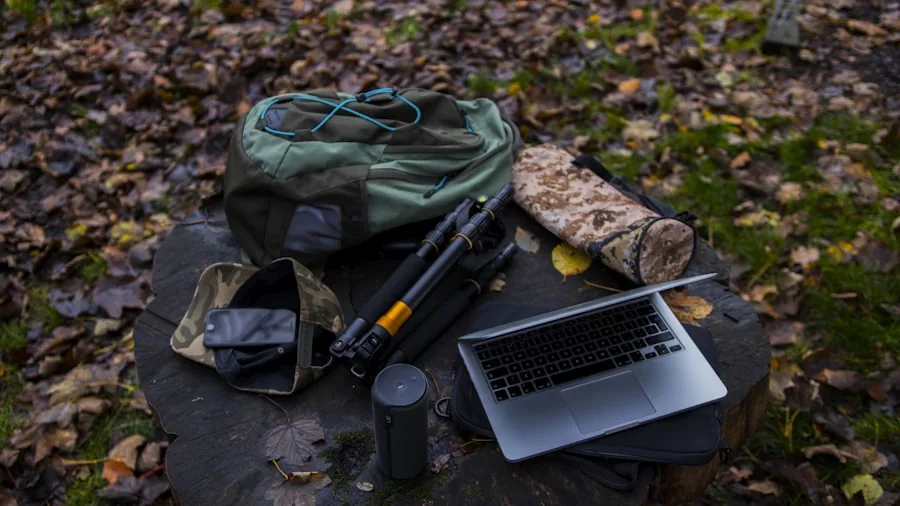 Person charging multiple devices at campsite with solar power setup during outdoor adventure