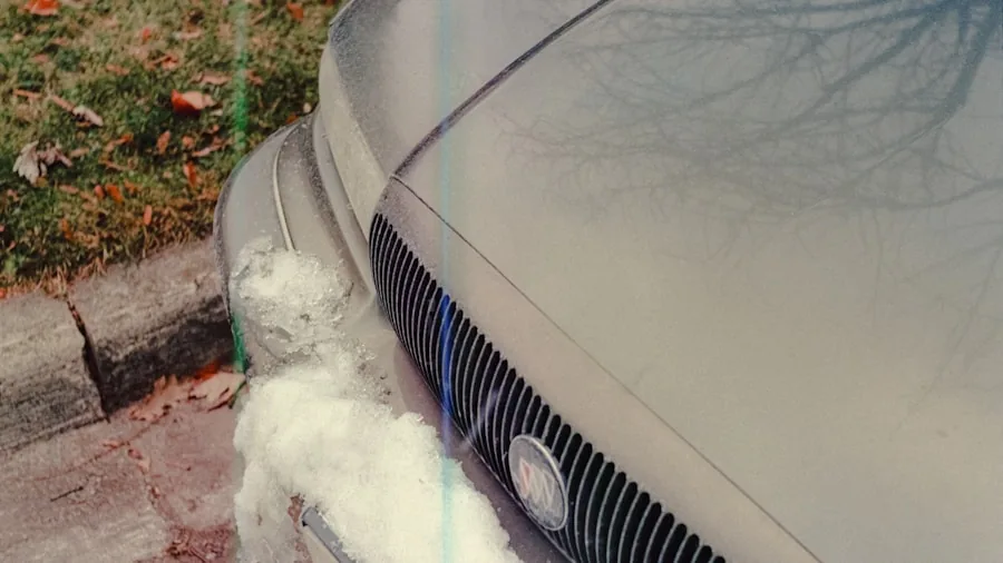 The %product_count% Best Car Batteries 3 Person checking car battery in snowy winter conditions outdoors