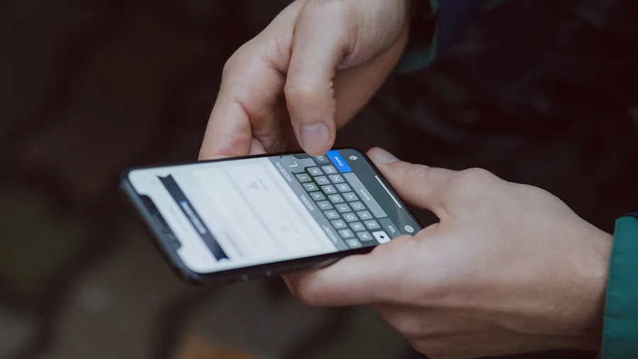 Person checking mobile app while standing in residential backyard with lawn visible