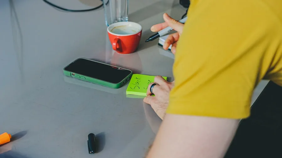 Person checking smartphone battery life while holding mobile device during daily activities