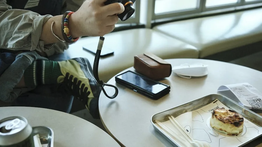 Person checking smartphone battery while traveling with power bank nearby on table