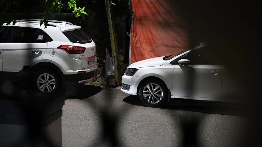 The %product_count% Best Remote Starters 5 Person checking vehicle security system on parked car in driveway at night