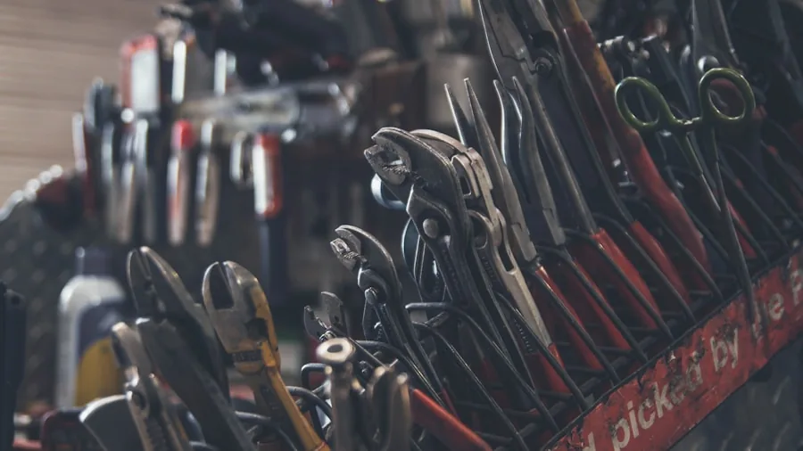 Person choosing appropriate tools for different DIY projects in a workshop setting
