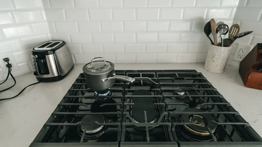 The %product_count% Best Ranges 5 Person cleaning and maintaining a gas stovetop in a modern kitchen